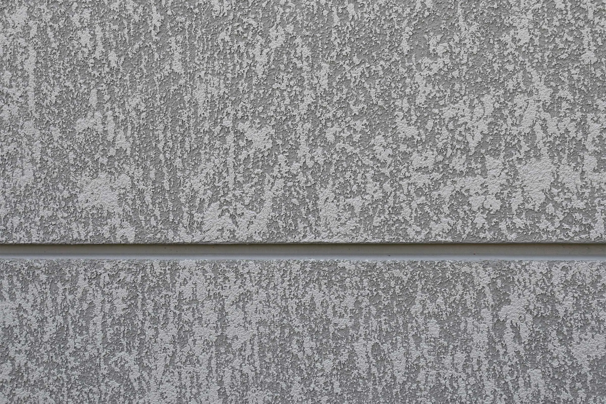 Nahaufnahme Fassadenbeschichtung in Beige - Natur