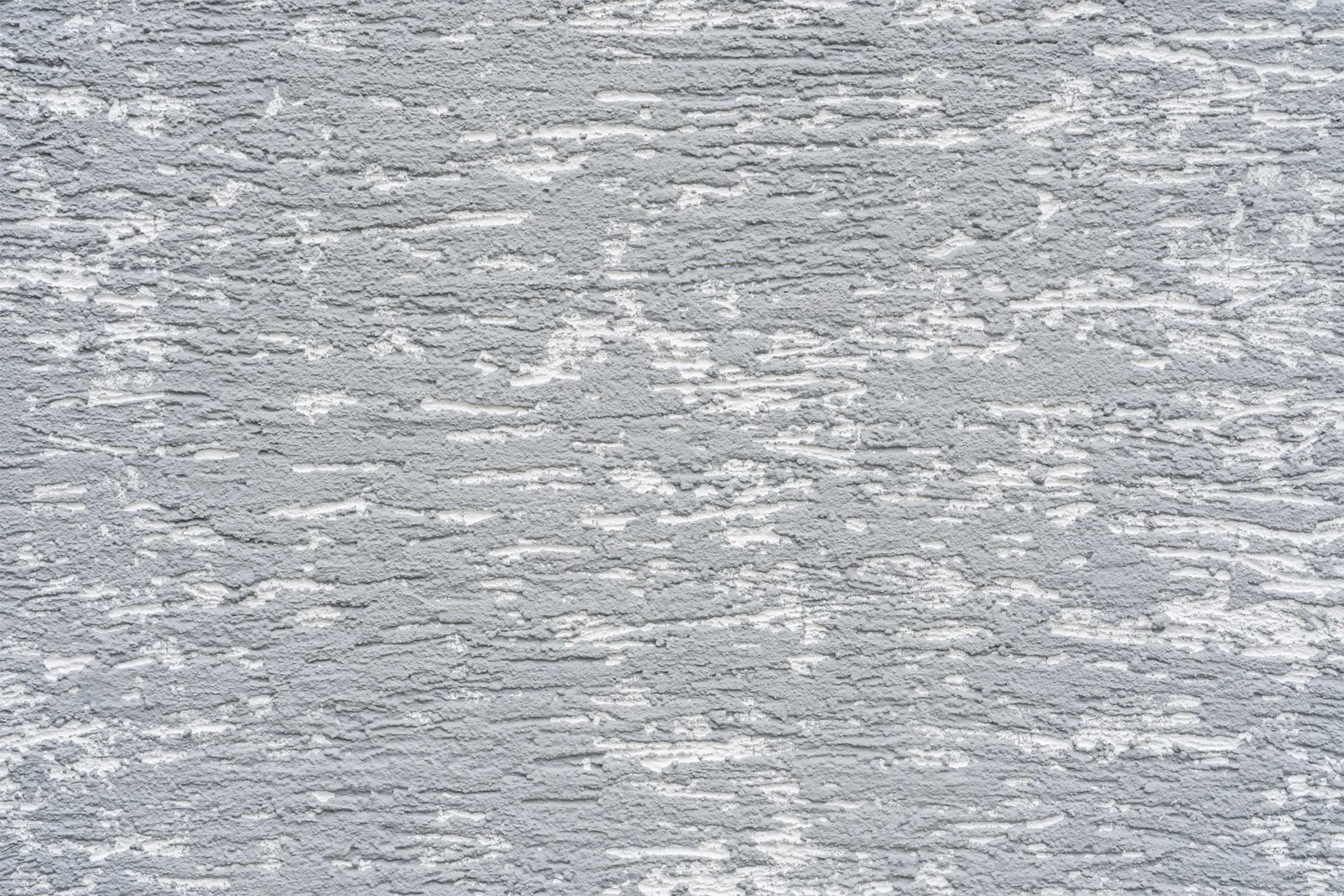 Ausschnitt von Fassade mit Putztechnik mit StoMiral Edelkratzputz in beige und creme