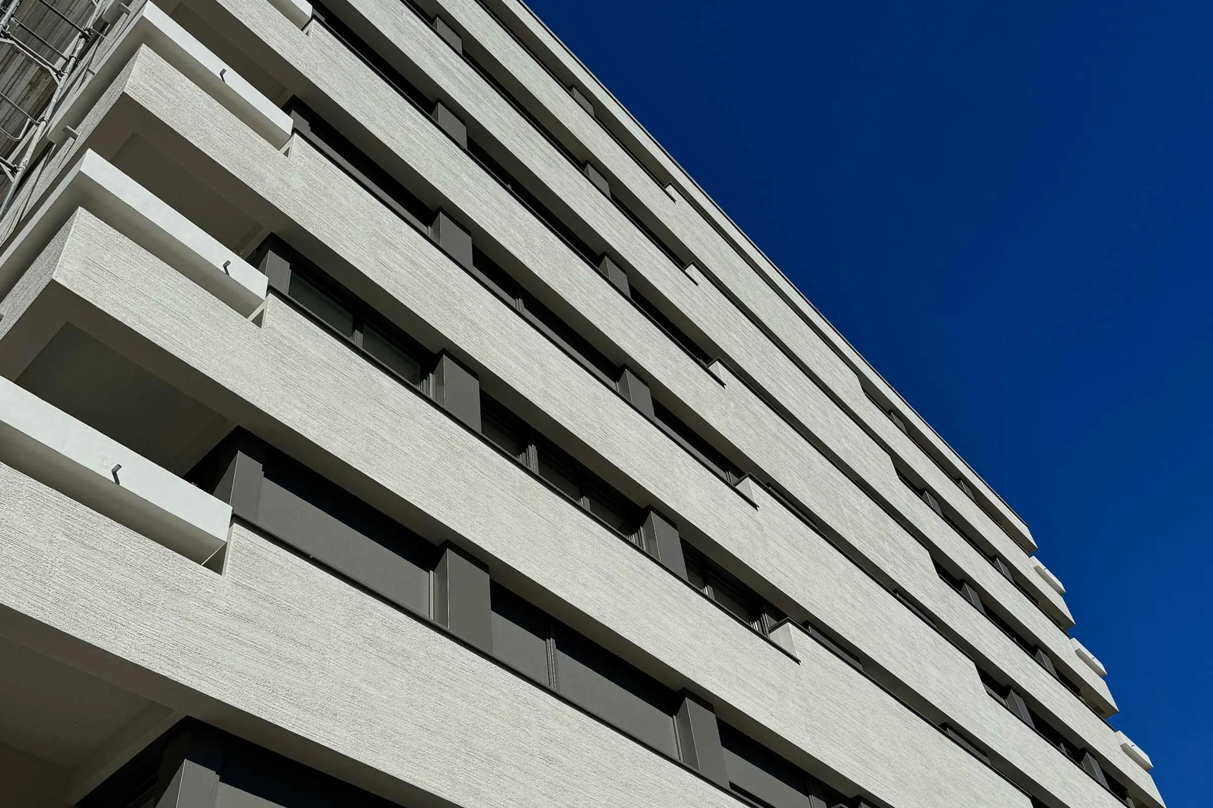 Ansicht von unten auf mehrstöckiges Wohn-und Geschäftshaus und die Balkone