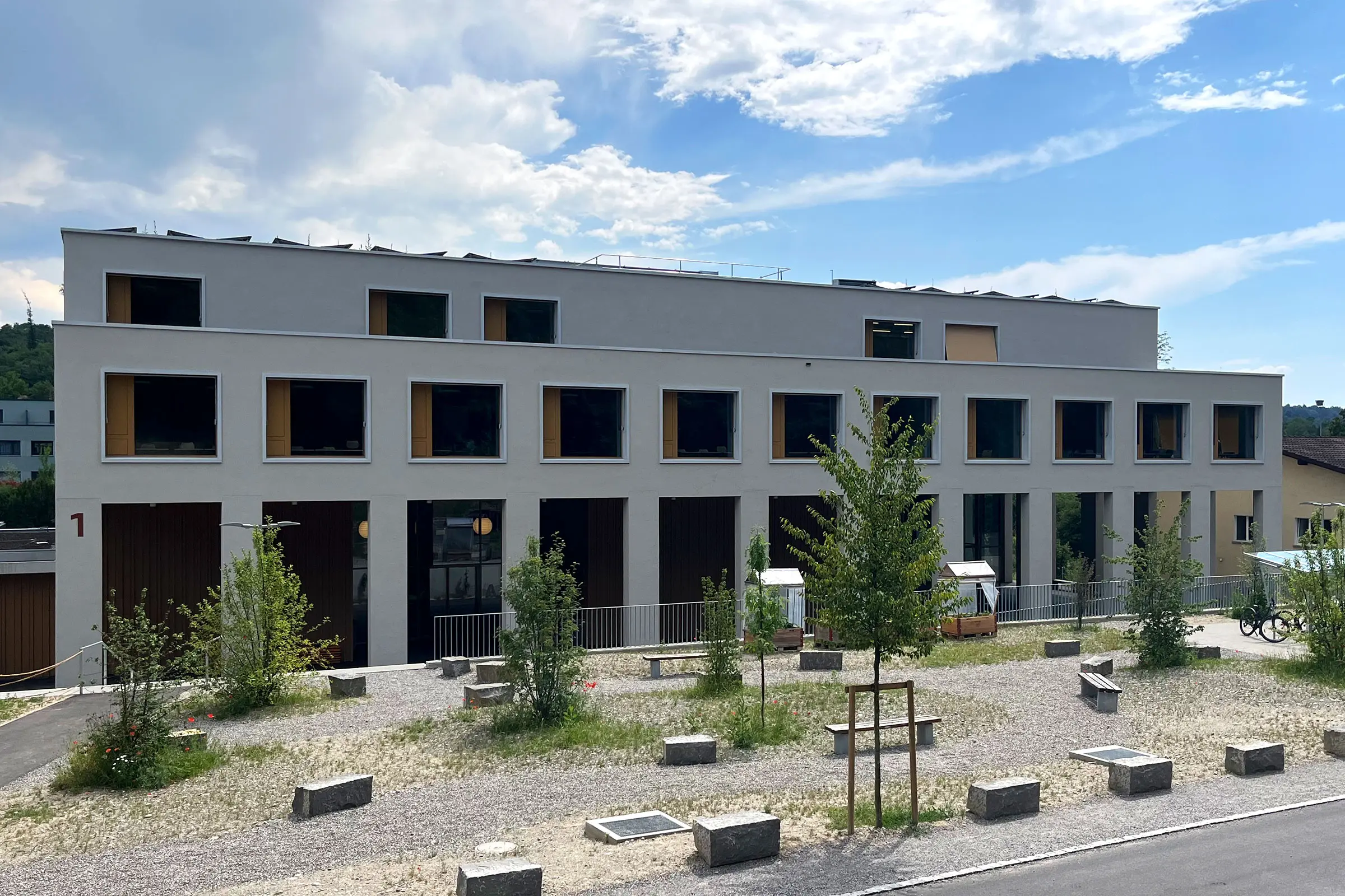 Neubau Schulzentrum Neuenegg von vorne mit beiger Fassadenbeschichtung