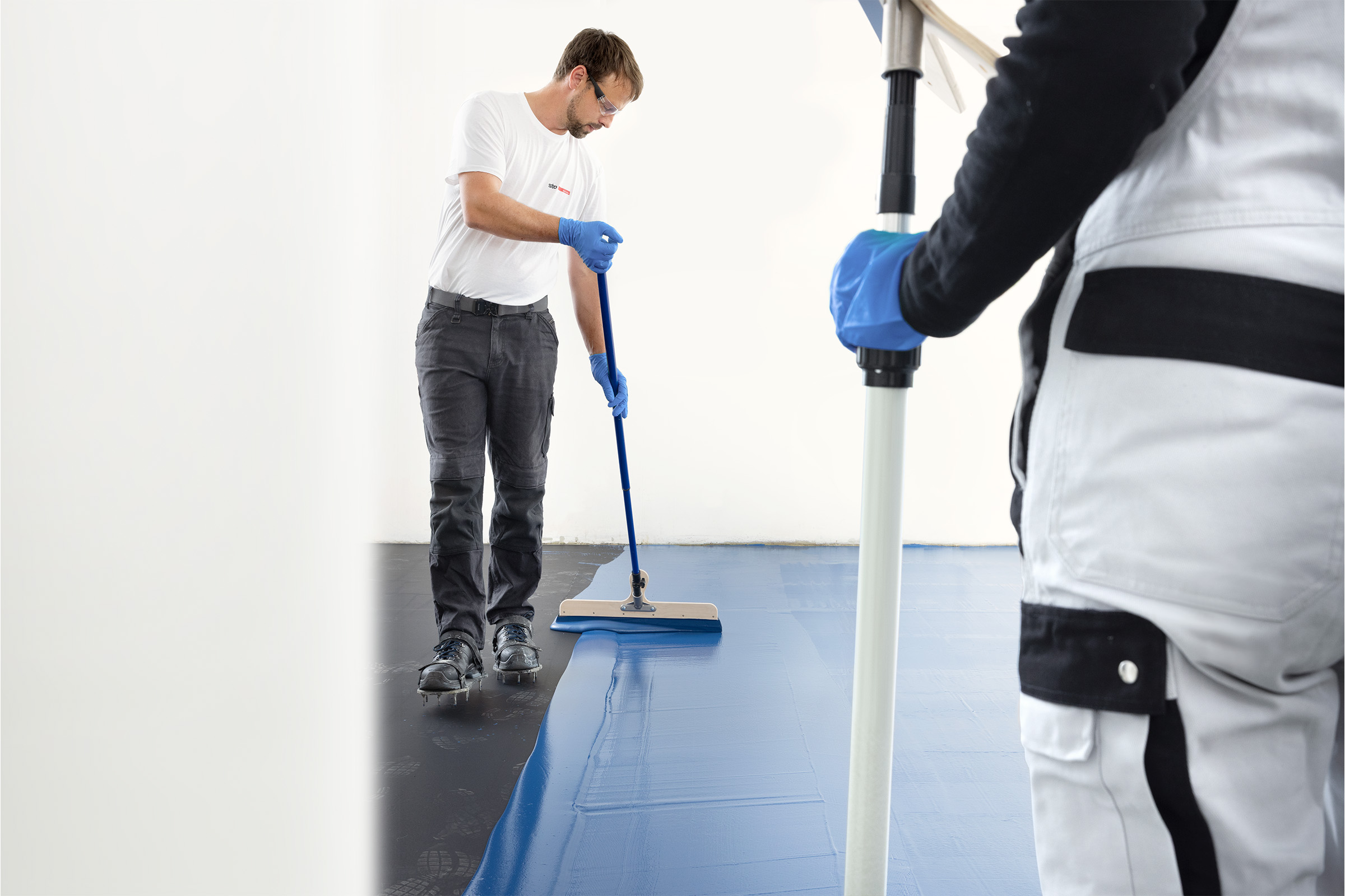 Facharbeiter verarbeitet die Bodenbeschichtung StoPox KU 406